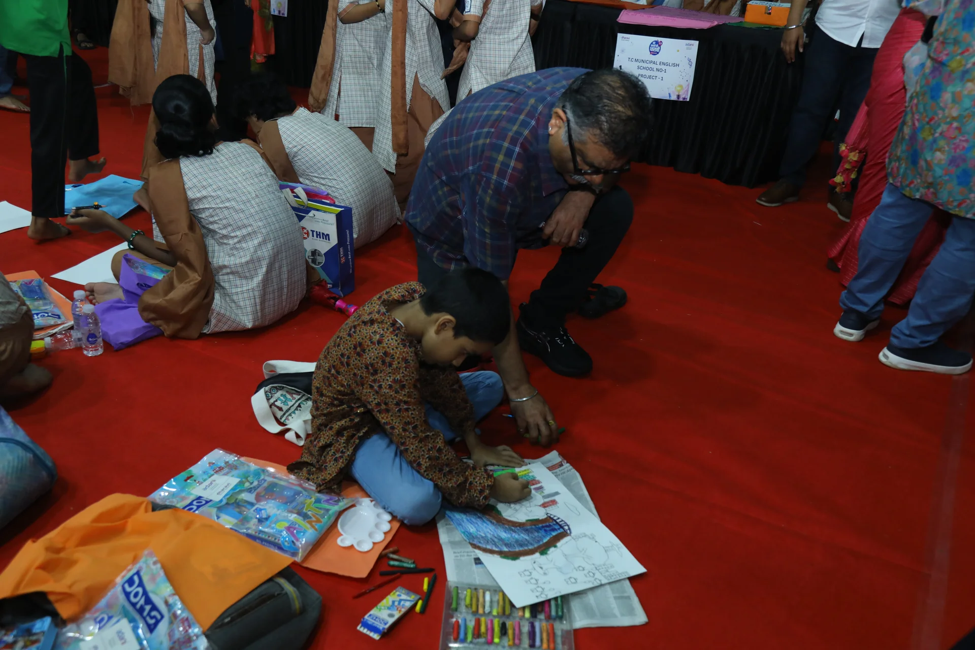 Mere Sapno Ki Dharavi 2.0 — Drawing activity with a student