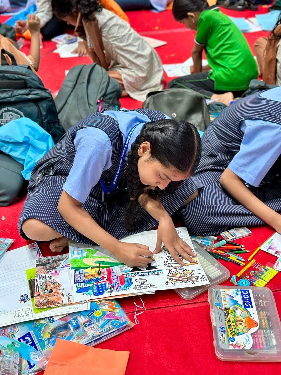 Mere Sapno Ki Dharavi 2.0 — Student colouring her artwork